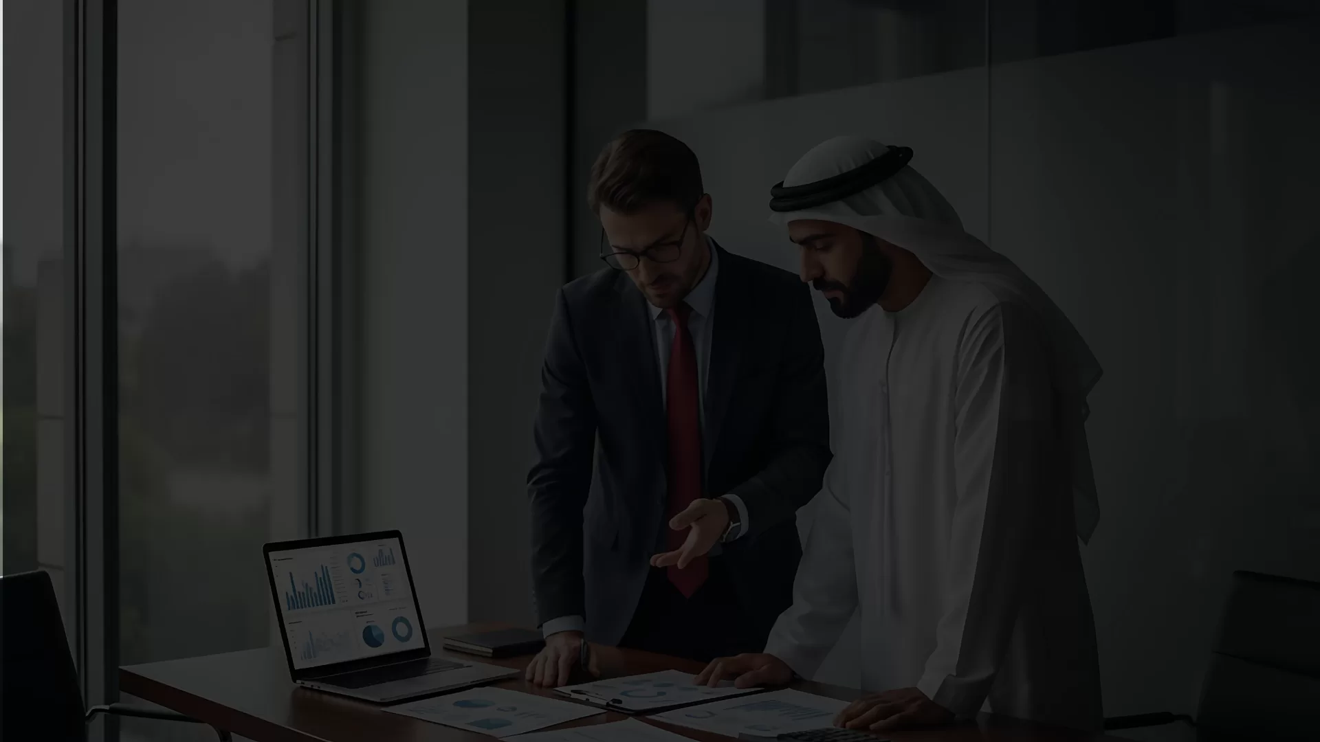 Financial advisor and client reviewing tax reports and audit documents in dubai office